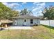 Backyard featuring a concrete patio, fenced yard, and shade trees at 610 Carolina Ave, St Cloud, FL 34769