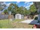 Backyard featuring a shed, concrete patio, and fenced yard at 610 Carolina Ave, St Cloud, FL 34769