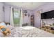 Cozy bedroom featuring purple walls and a window overlooking the yard at 610 Carolina Ave, St Cloud, FL 34769