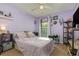 Cozy bedroom with purple walls, plush carpeting, and a ceiling fan at 610 Carolina Ave, St Cloud, FL 34769