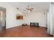 Living room featuring wood floors, neutral walls, and an open concept view to the kitchen at 610 Carolina Ave, St Cloud, FL 34769