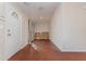 Bright living room with wood floors and a white front door with decorative window at 610 Carolina Ave, St Cloud, FL 34769