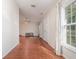 View of the open-concept living room featuring wood floors, a ceiling fan, and a front door at 610 Carolina Ave, St Cloud, FL 34769