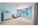 Light blue bedroom with a large dresser, small sofa and window with blue curtains at 7344 Woodglen Ct, Orlando, FL 32835