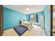 Bright blue bedroom featuring a bed, window with curtains, and a wardrobe at 7344 Woodglen Ct, Orlando, FL 32835