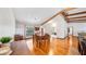 Bright dining room featuring wood floors, wood beams, and a large window for natural light at 7344 Woodglen Ct, Orlando, FL 32835