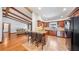 Kitchen with an island and seating that opens to a living room with a fireplace and wood beams at 7344 Woodglen Ct, Orlando, FL 32835