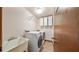 Laundry room featuring a sink, washer, dryer, and shelving at 7344 Woodglen Ct, Orlando, FL 32835