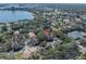 Scenic aerial view of townhomes near a lake, showcasing lush greenery and serene community setting at 7532 Bay Port Rd # 18, Orlando, FL 32819