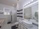 Bathroom featuring a vessel sink, glass shower, and black and white accent tiles at 7532 Bay Port Rd # 18, Orlando, FL 32819