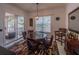 Elegant dining area with a unique table, cozy seating, and sliding glass doors leading to outdoor area at 7532 Bay Port Rd # 18, Orlando, FL 32819