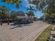 Community entry gate with brick paved drive and well maintained landscaping at 7532 Bay Port Rd # 18, Orlando, FL 32819