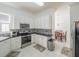 Bright, modern kitchen featuring white cabinetry, sleek appliances, and stylish backsplash, perfect for cooking at 7532 Bay Port Rd # 18, Orlando, FL 32819