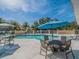 Community pool with tables, chairs, and umbrellas for relaxing by the pool at 7532 Bay Port Rd # 18, Orlando, FL 32819