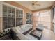 Relaxing screened-in porch with comfortable seating, a ceiling fan, and views of the backyard at 7532 Bay Port Rd # 18, Orlando, FL 32819