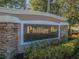 Stone and stucco sign for Phillips Bay community with manicured landscaping at 7532 Bay Port Rd # 18, Orlando, FL 32819