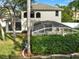 Two-story home featuring a screened pool enclosure and well-maintained landscaping at 795 Sterling Chase Dr, Port Orange, FL 32128