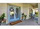 Charming blue double front door with decorative wreaths, a welcome mat, potted plants, and a view of the porch at 795 Sterling Chase Dr, Port Orange, FL 32128