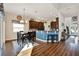 Open-concept kitchen with island seating, dark wood cabinetry and dining table with chairs at 795 Sterling Chase Dr, Port Orange, FL 32128