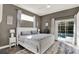 Cozy main bedroom with neutral colors, plush rug, and sliding doors to pool area at 795 Sterling Chase Dr, Port Orange, FL 32128