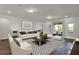 Modern living room featuring stylish decor, hardwood floors, and sliding glass doors to the patio at 7952 Wandering Way, Orlando, FL 32836