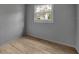 Bedroom with hardwood floors, neutral paint and a window letting in natural light at 807 Vercelli St, Deltona, FL 32725