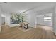 Bright dining room features wood floors, statement wall decor, and a modern chandelier lighting the table at 807 Vercelli St, Deltona, FL 32725