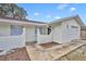 Front exterior view of a freshly painted home showing the front entry and attached garage at 807 Vercelli St, Deltona, FL 32725