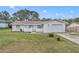 Charming single-story home featuring a well-maintained lawn, attached garage, and freshly painted exterior at 807 Vercelli St, Deltona, FL 32725