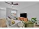 Bright living room featuring modern flooring, neutral paint, a ceiling fan, and stylish decor at 807 Vercelli St, Deltona, FL 32725