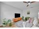 Bright living room featuring modern flooring, neutral paint, a ceiling fan, and stylish decor at 807 Vercelli St, Deltona, FL 32725