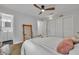 Comfortable bedroom with wood-look floors, neutral walls, and a view to the ensuite bathroom and closet at 807 Vercelli St, Deltona, FL 32725