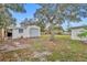 This backyard features a detached storage shed with roll-up door at 807 Vercelli St, Deltona, FL 32725