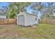 This backyard offers a storage shed with a roll-up garage door and separate entry door at 807 Vercelli St, Deltona, FL 32725