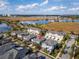 Beautiful aerial view of townhomes near a lake and golf course offering scenic views at 8163 Upper Perse Cir, Orlando, FL 32827