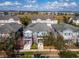 Real estate aerial view of townhomes in a residential neighborhood with mature trees and walkable sidewalks at 8163 Upper Perse Cir, Orlando, FL 32827