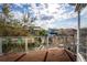 Outdoor balcony with wood deck, clear railing and view of lush landscaping at 8163 Upper Perse Cir, Orlando, FL 32827