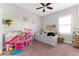 Bright bedroom features a ceiling fan and a playful dollhouse at 8163 Upper Perse Cir, Orlando, FL 32827