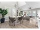 Elegant dining area featuring a modern chandelier, a round table, and access to the open-concept living space at 8163 Upper Perse Cir, Orlando, FL 32827