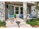 Inviting front porch with sleek columns, light gray walls, and comfortable blue chairs, perfect for relaxing at 8163 Upper Perse Cir, Orlando, FL 32827