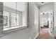 Upstairs hallway with neutral walls and carpet leading to a bedroom at 8163 Upper Perse Cir, Orlando, FL 32827