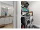 This laundry room features a full-sized washer and dryer, with storage and a utility sink at 8163 Upper Perse Cir, Orlando, FL 32827