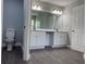 Bathroom featuring a double sink vanity, large mirror with light fixtures and wood floors at 8315 Sw 135Th Street Rd, Ocala, FL 34473