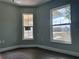 Corner bedroom with wood floors, fresh paint, and abundant natural light at 8315 Sw 135Th Street Rd, Ocala, FL 34473