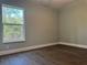 Cozy bedroom with wood floors, fresh paint, and abundant natural light at 8315 Sw 135Th Street Rd, Ocala, FL 34473