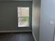 Bedroom featuring wood-look floors, a large window, and light-colored walls at 8315 Sw 135Th Street Rd, Ocala, FL 34473