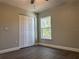 Bedroom features a double door closet, laminate floors, and a bright window overlooking foliage at 8315 Sw 135Th Street Rd, Ocala, FL 34473