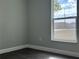 Bright bedroom featuring wood floors, fresh paint, and a large window at 8315 Sw 135Th Street Rd, Ocala, FL 34473