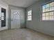 Inviting enclosed entrance porch featuring tile flooring, and ample natural light through the windows at 8315 Sw 135Th Street Rd, Ocala, FL 34473