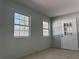 Enclosed porch featuring ceramic tile floors, two windows, and 2 doors at 8315 Sw 135Th Street Rd, Ocala, FL 34473